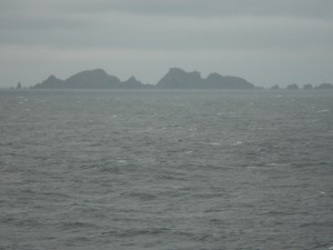 Crags rising gloomily in the mist (Cape Horn).